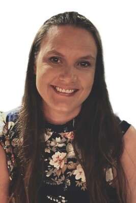Alumna Mikayla Lythgo wearing a floral top