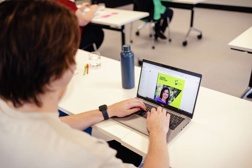 Student on laptop looking at course directory