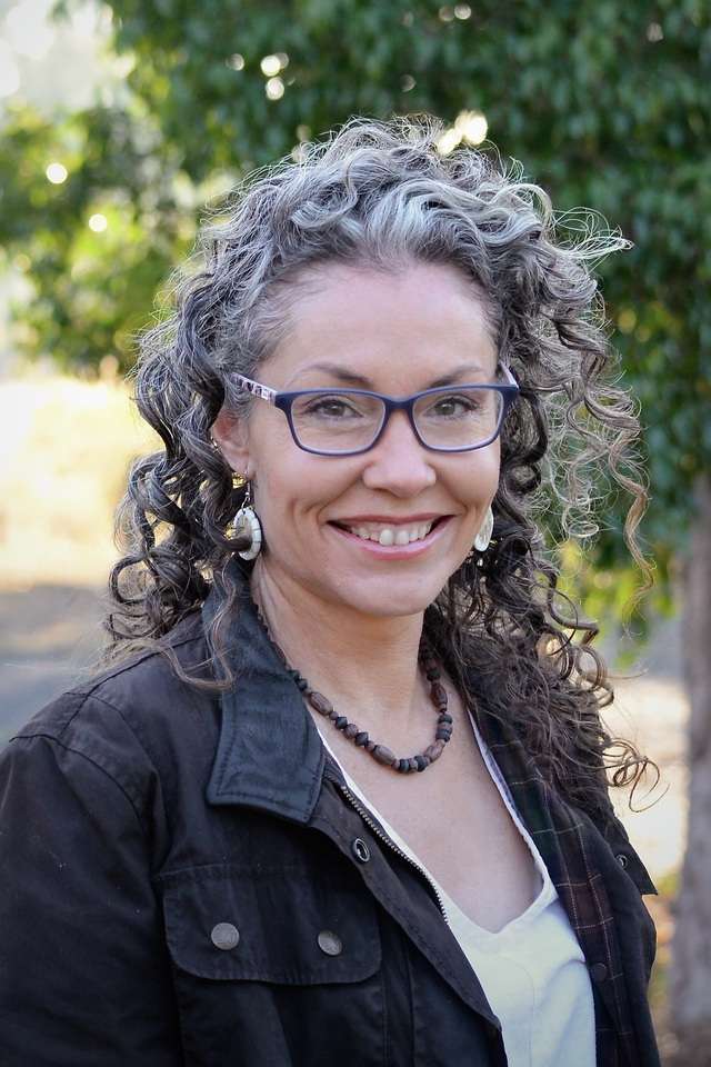Alumna Misty Neilson wearing glasses