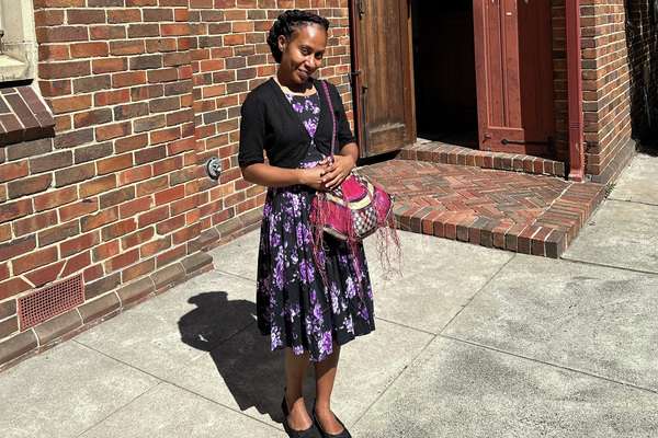 Master of Laboratory Medicine international student Natasha Philip standing in front of brick house.