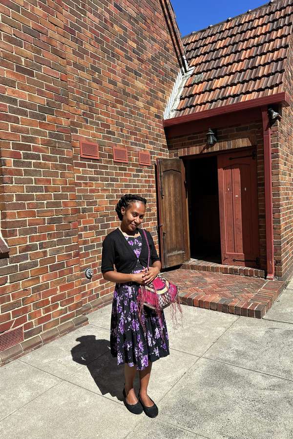 Master of Laboratory Medicine international student Natasha Philip standing in front of brick house.