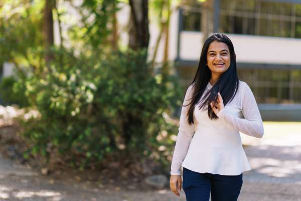 CQUniversity student smiles while walking through the campus.