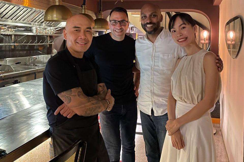 Four people standing in a restaurant