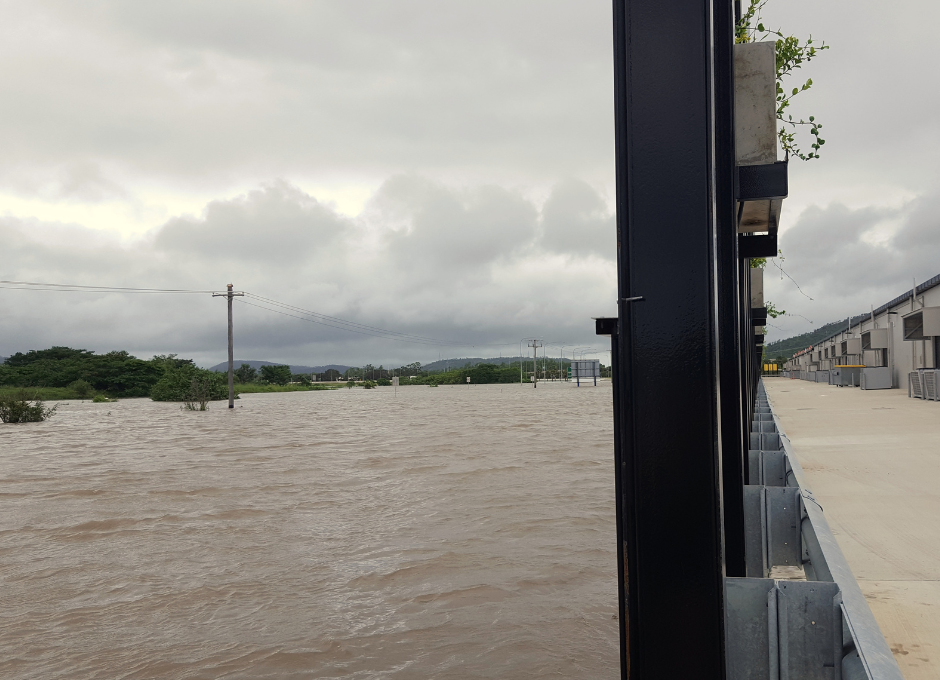 Rising water next to an industrial building