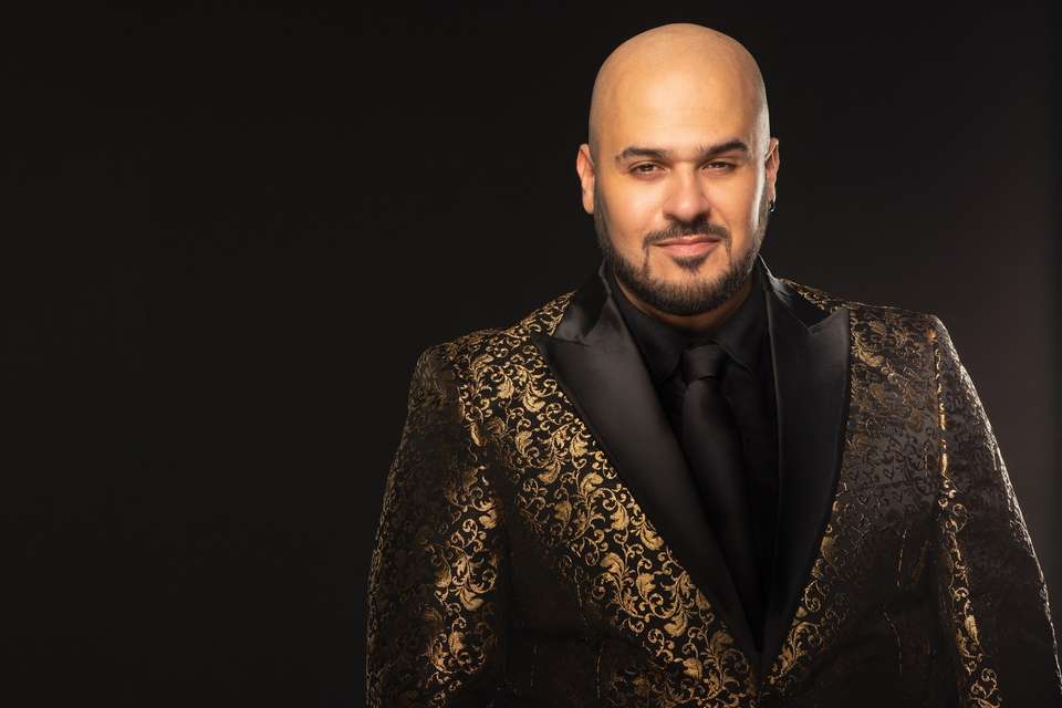 A portrait of a man, Paul Tabone, wearing a suit.
