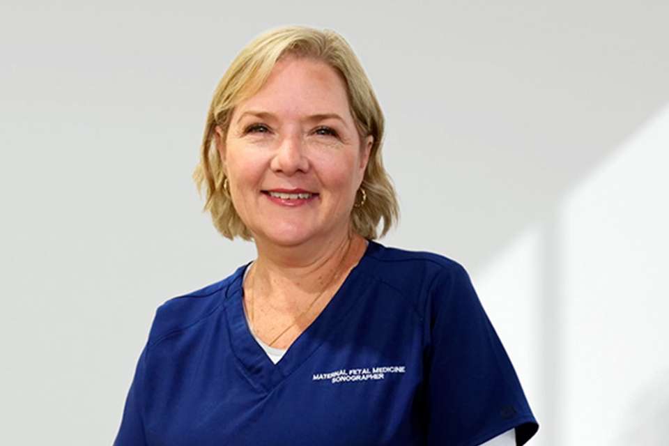 Smiling woman in scrubs