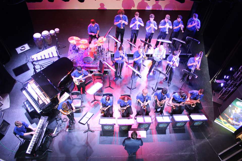 Ariel image of young students on stage playing instruments