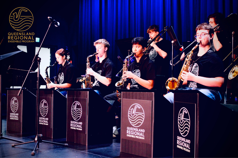 Group of young people on a stage playing instruments