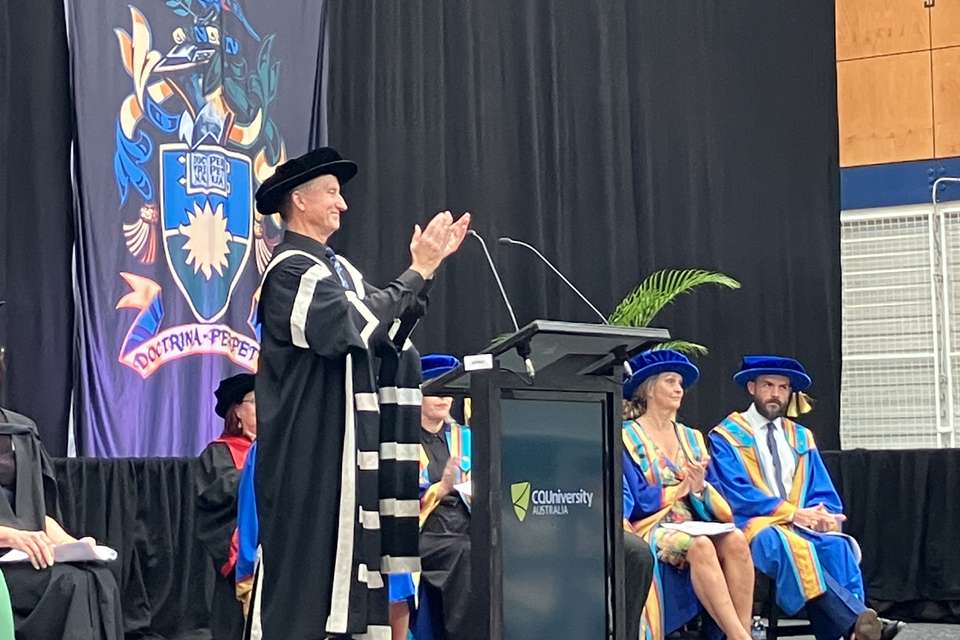 People in regalia on a stage