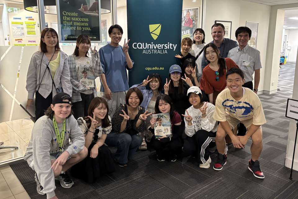 Group of students standing with CQU sign