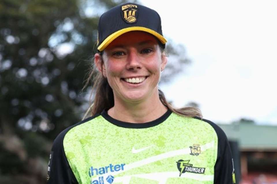 Woman in a cricket uniform