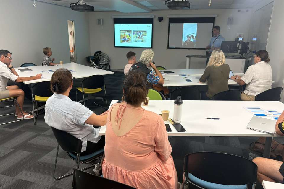Participants sitting at tables in a classroom
