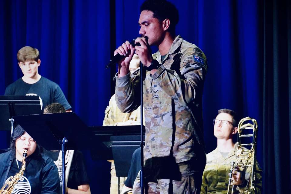 Man in uniform signing on stage