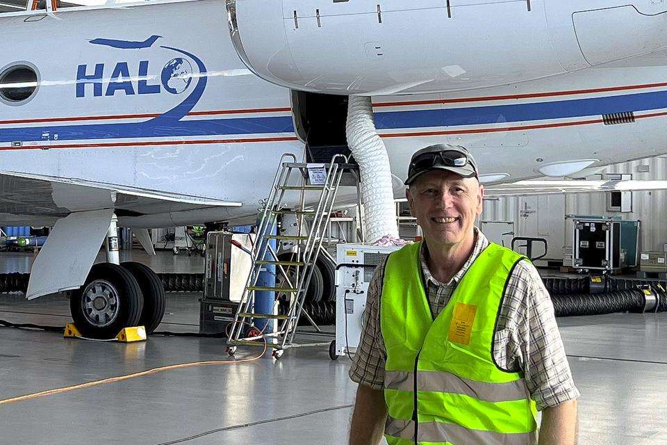 CQU Geography Dr Michael Hewson in front of the High Altitude – Long Range (HALO) aircraft