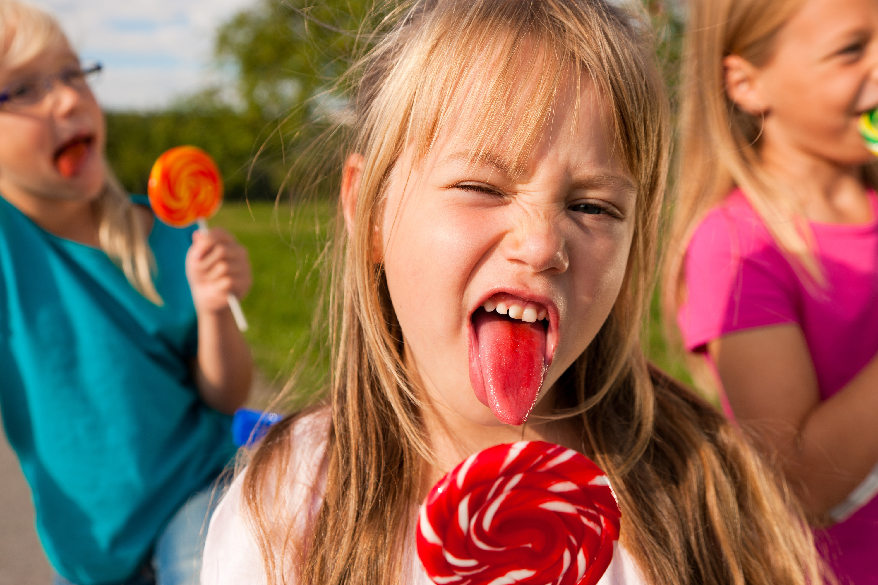 Children eating lollipops