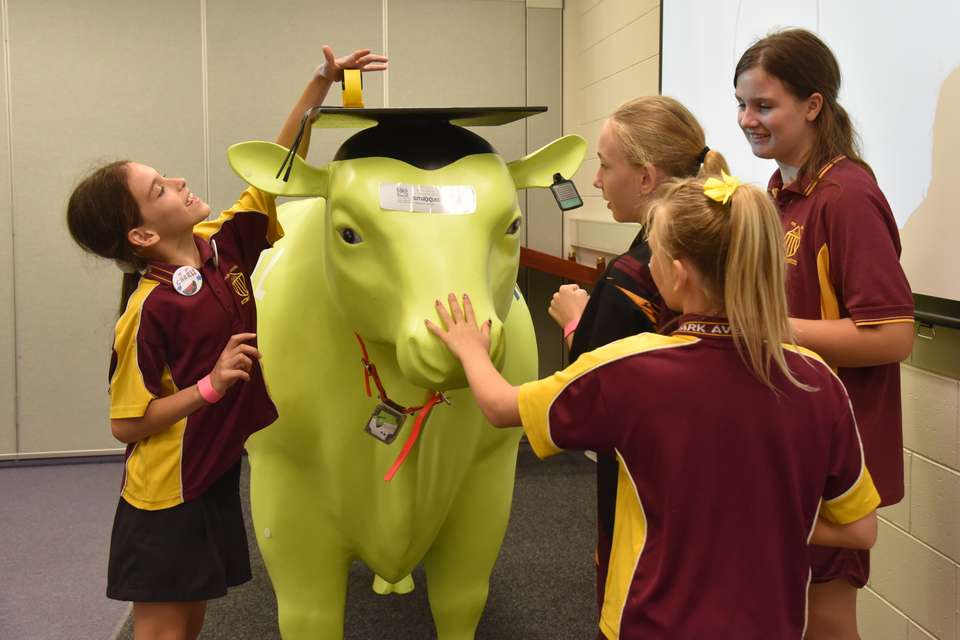 school children put devices on fake bull wearing a mortarboard.JPG