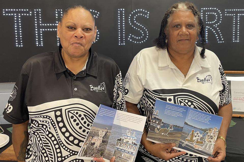 Byellee Elder and First Nations Artist Trish (Patricia Coleman) and Byellee Elder stand with copies of books written and illustrated by local Gladstone children
