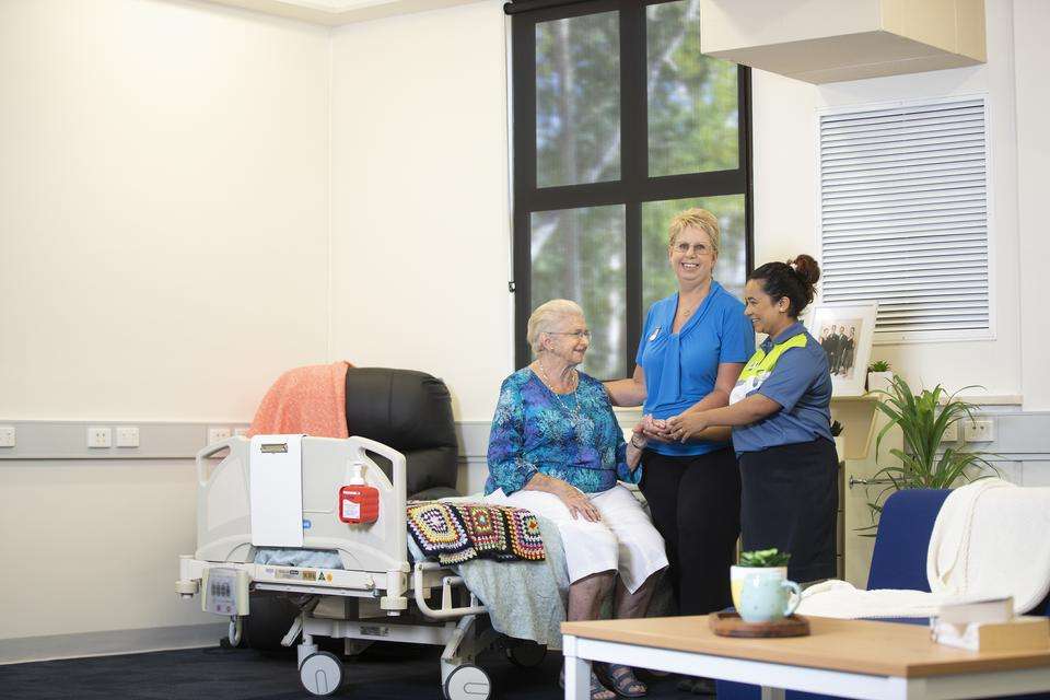 Image of female CQU teacher and student with female senior in an aged care setting