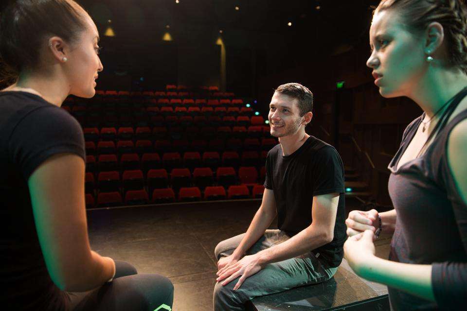 People on stage in a theatre