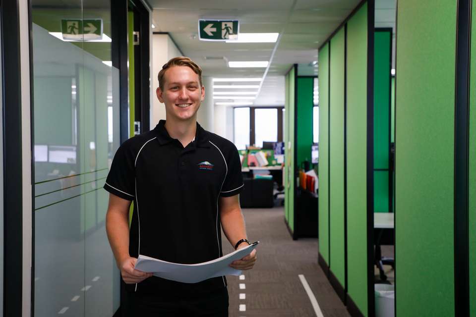 Jordan Ven Den Barselaar pictured at work holding engineering documents