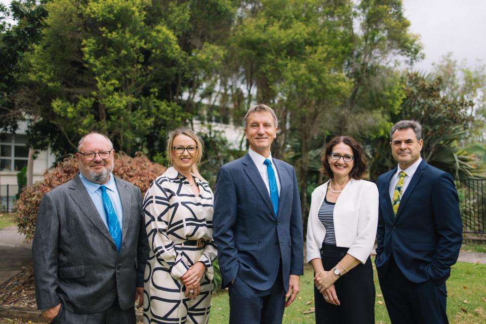 Left to right Professor Jonathan Powels, Narelle Pearse, Professor Nick Klomp, Professor Michelle Bellingan and Professor Grant Stanley. The group stand side by side near a garden on the chancellery lawns at the Rockhampton North campus