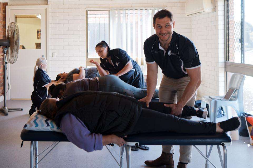 chiropractic students in a clinic setting working with patients.jpg