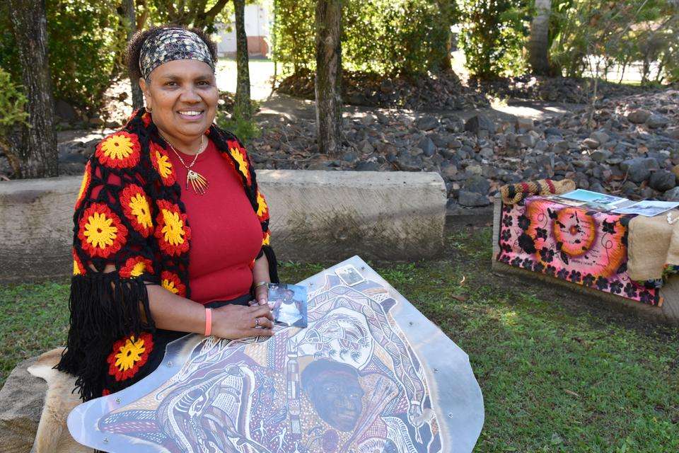 Leonie Taylor smiles as she displays art and photos from her Elders