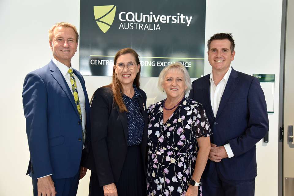 four people including VC, state and federal members, in front of sign with logo.JPG