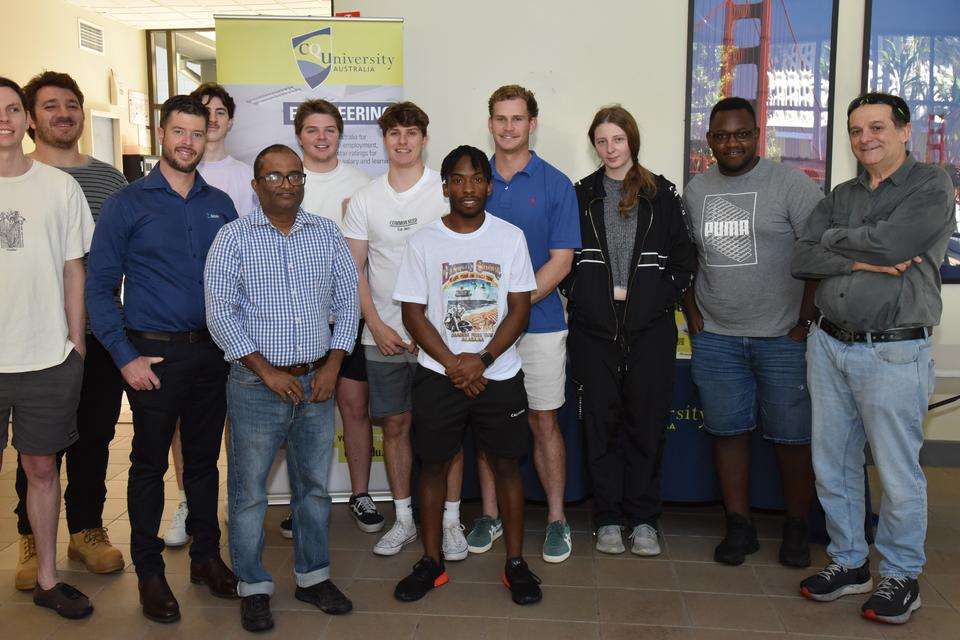 Group of engineering students stand smiling at the camera with their academic teachers and cqu alumnus guest lecturer