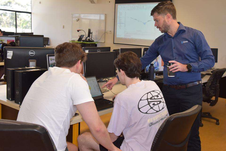 Patrick Doig instructs students with mining engineering software in a computer lab