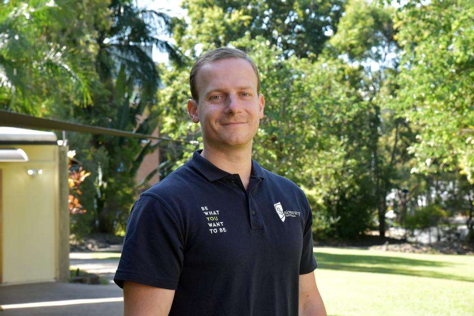 Head of Course for Podiatry Dr Ben Peterson stands on the campus lawns at CQUniversity Rockhampton North