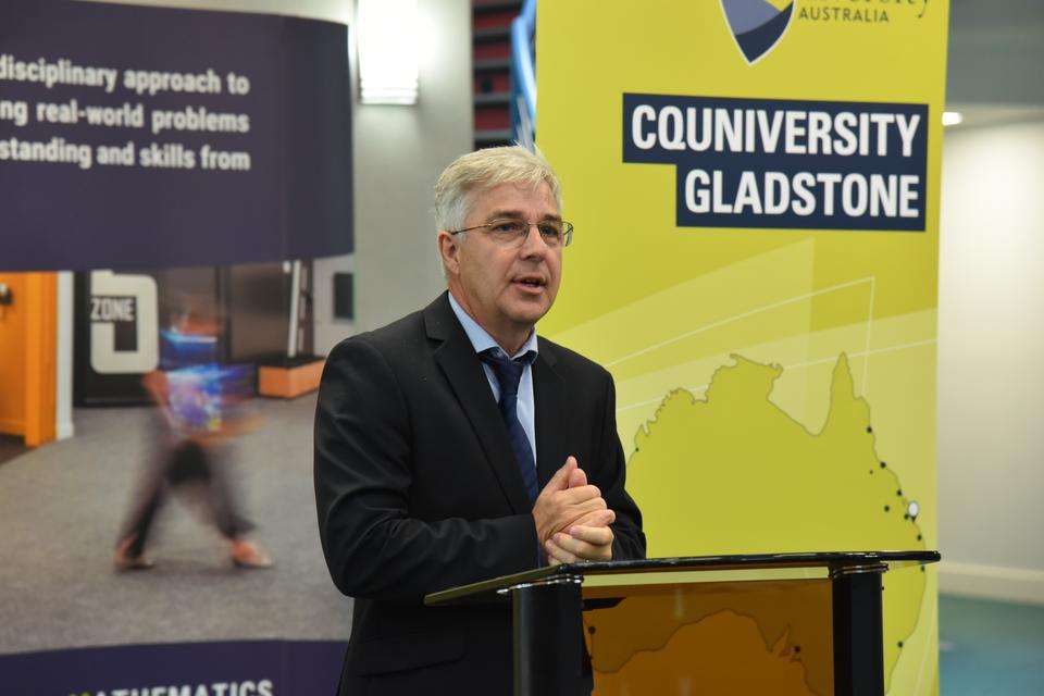 Professor Jonathan Love delivers a speech at a lectern