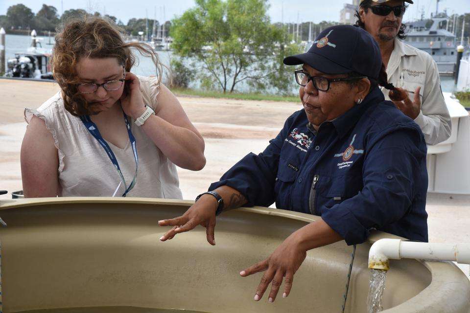 Gidarjil Development Corporation Sea Ranger Markeeta Sullivan at seagrass nursery tank with forum participant.JPG