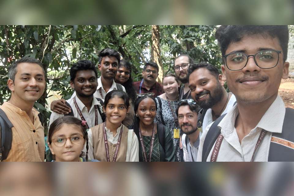 Image of adults and children in a forest type setting in India