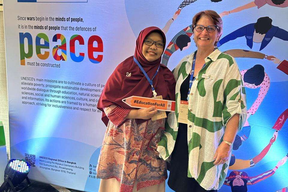 Dr Yuli Rahmawati from the Universitas Negeri Jakarta with Dr Karena Menzie-Ballantyne in from of a UNESCO peace banner.jpg