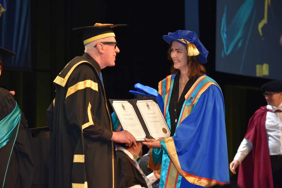 Man presenting a woman a certificate