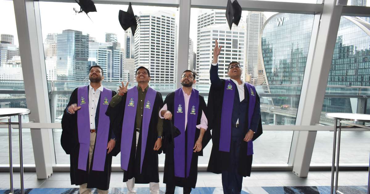 Sydney graduates throwing their caps in celebration