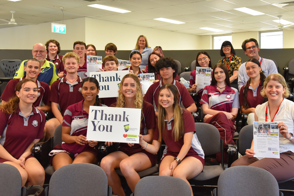North Rockhampton State High School students and supporters some holding thank you cards