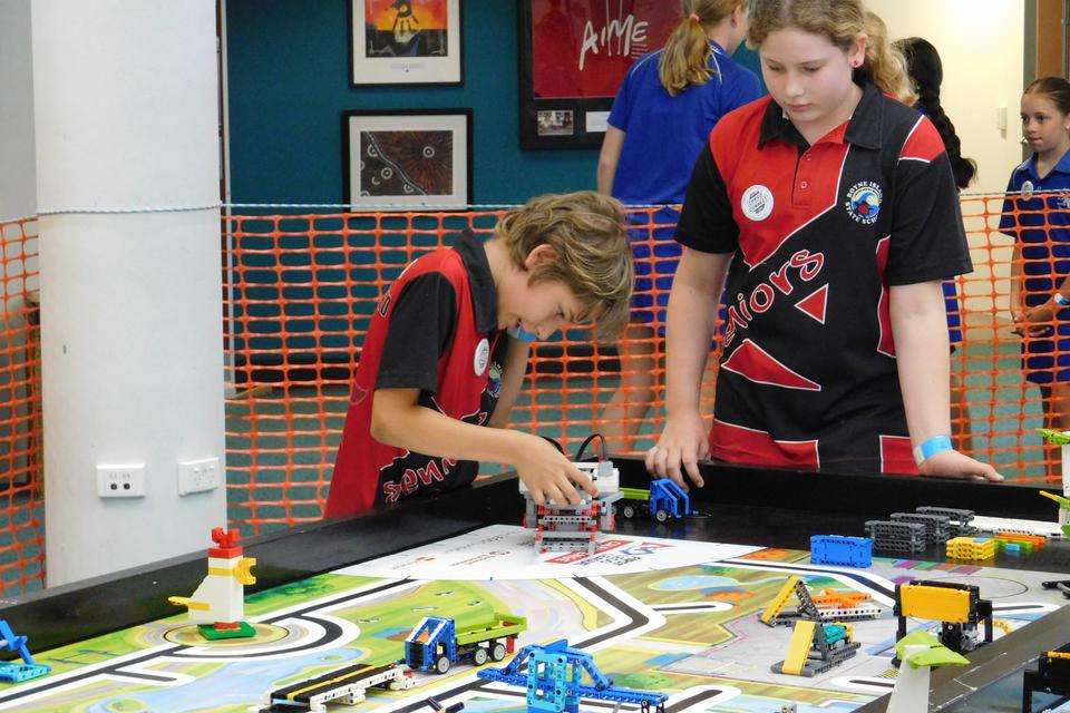 Two school students from Boyne Island State School construct Lego during a STEM tournament in Gladstone in 2021