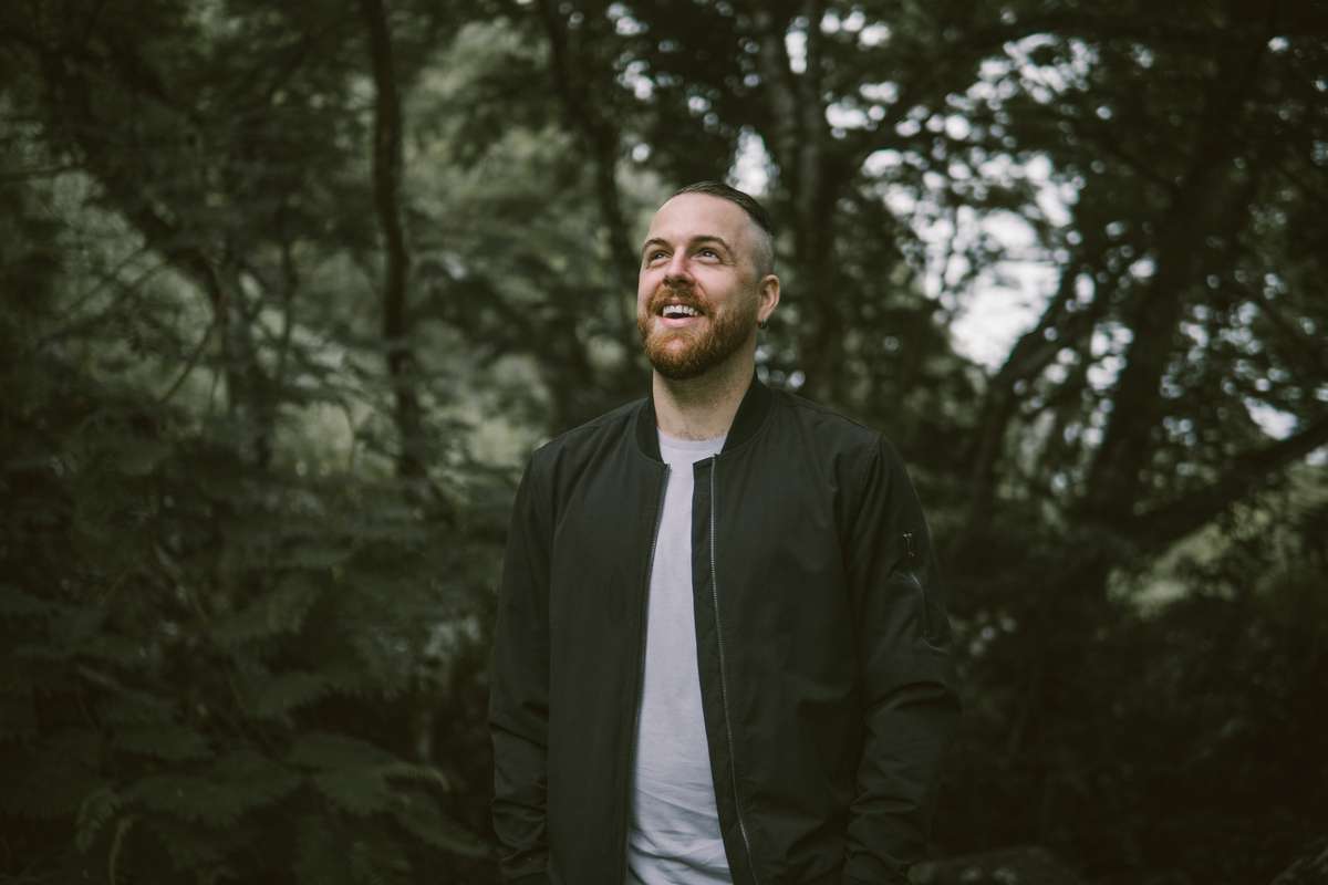 Alumnus Tristan Barton outdoors and wearing a jacket
