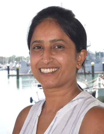 Headshot of Dr Nirali Kumar with Gladstone Harbour in the background