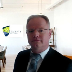 Noal Atkinson wearing glasses and smiling