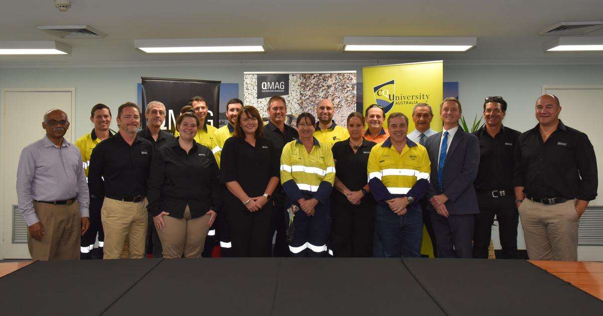 Representatives and staff of CQU and QMAG stand smiling at the camera to celebrate signing of Memorandum of Understanding