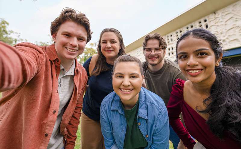 Group of students on campus at CQU smiling and looking at the camera.