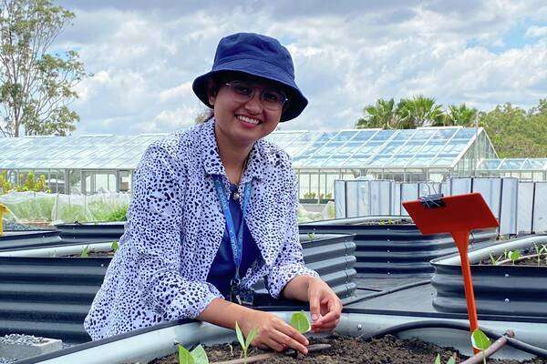 Pasmita Neupane checking on seedlings in outdoor nursery