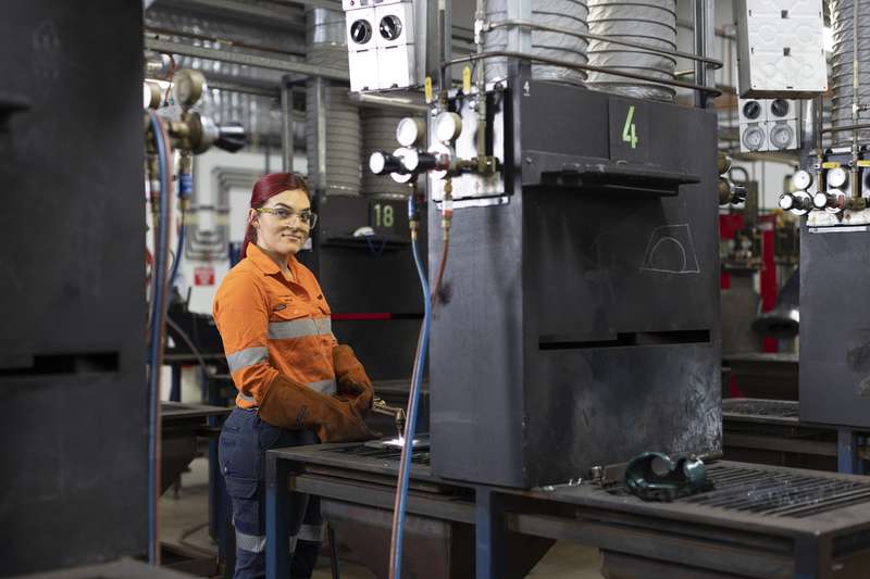 TAFE student welding in a industrial workshop wearing PPE