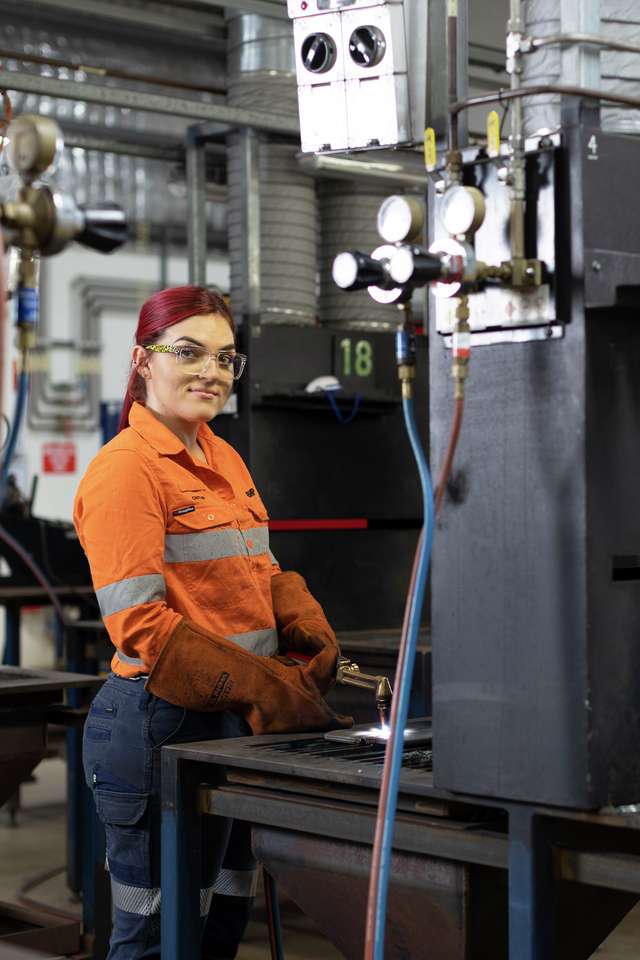 TAFE student welding in a industrial workshop wearing PPE