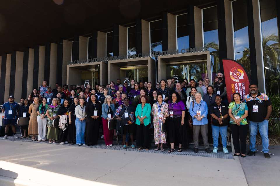 A large group of people stand outside the Mackay Entertainment and Convention Centre.