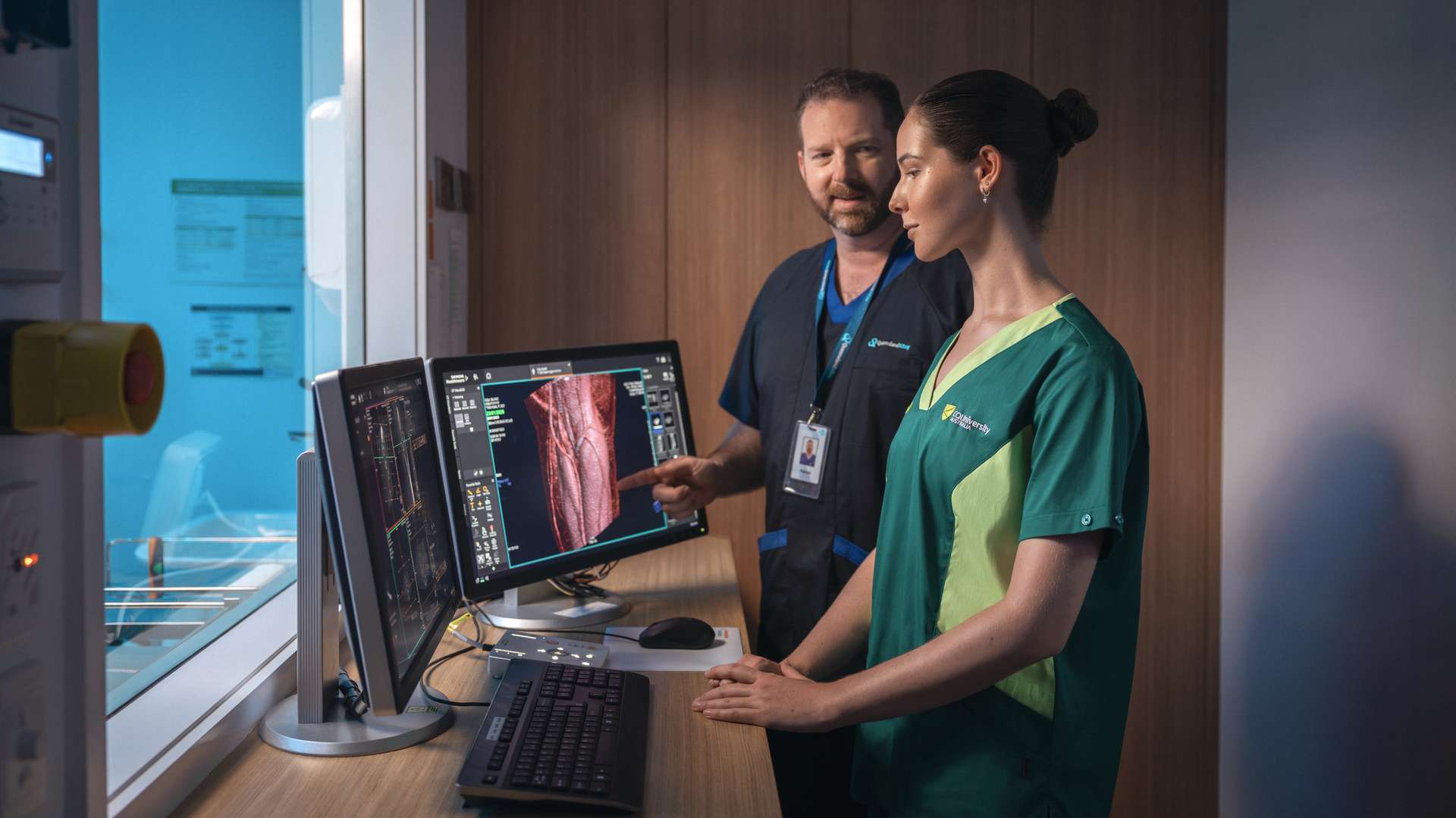 Lecturer showing a student a scan of a human body in a radiology room