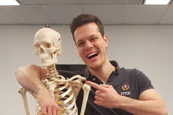 Riccardo Mura posing with an educational skeleton model